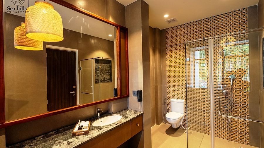 Modern bathroom with a glass shower enclosure, sleek countertop, and stylish lighting fixtures - Sea Hills Resort, Swaraj Dweep (Havelock)