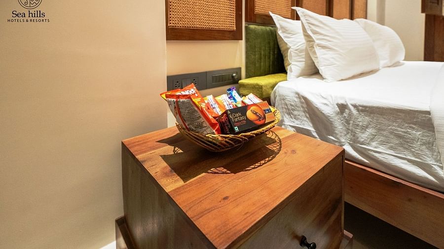 Wooden bedside table adorned with fresh fruit and decorative items, creating a warm, inviting atmosphere - Sea Hills Resort, Swaraj Dweep (Havelock)