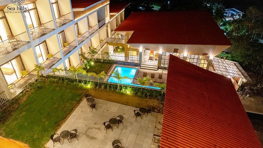 An aerial night view of a hotel building with a swimming pool, illuminated against a dark sky. - Sea Hills Resort, Swaraj Dweep (Havelock)