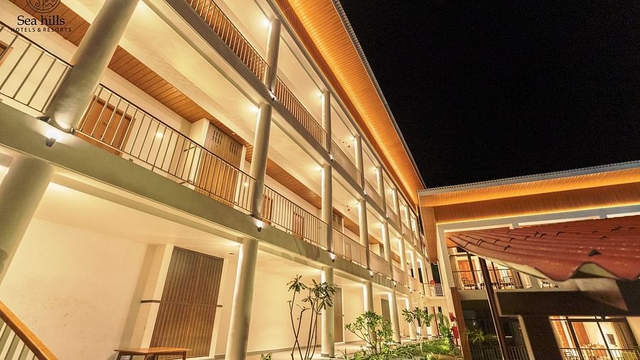 An exterior shot of a multi-story hotel building with balconies, illuminated at night. - Sea Hills Resort, Swaraj Dweep (Havelock)