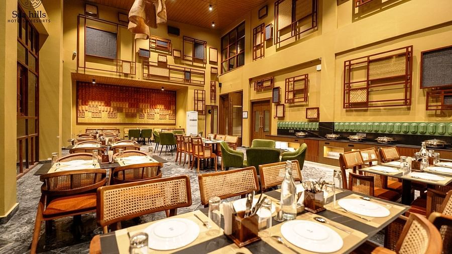 A well-lit restaurant interior with numerous tables and chairs - Sea Hills Resort, Swaraj Dweep (Havelock)
