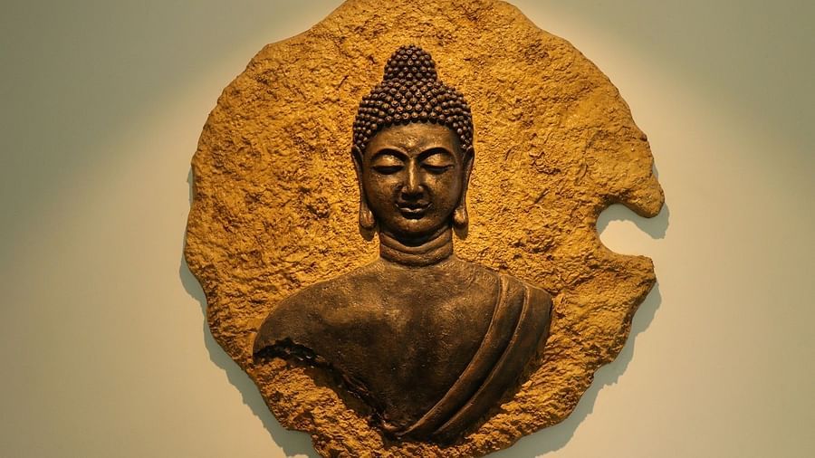 A circular wall hanging made of natural material, featuring a relief sculpture of Buddha's head on a lotus leaf - Sea Hills Hotels, Sri Vijaya Puram (Port Blair)