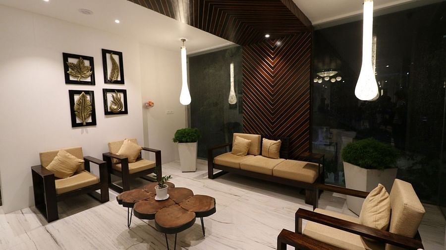 Another view of the hotel lounge area at night, slightly closer, highlighting the modern furniture and the warm, inviting ambiance - Sea Hills Hotels, Sri Vijaya Puram (Port Blair)