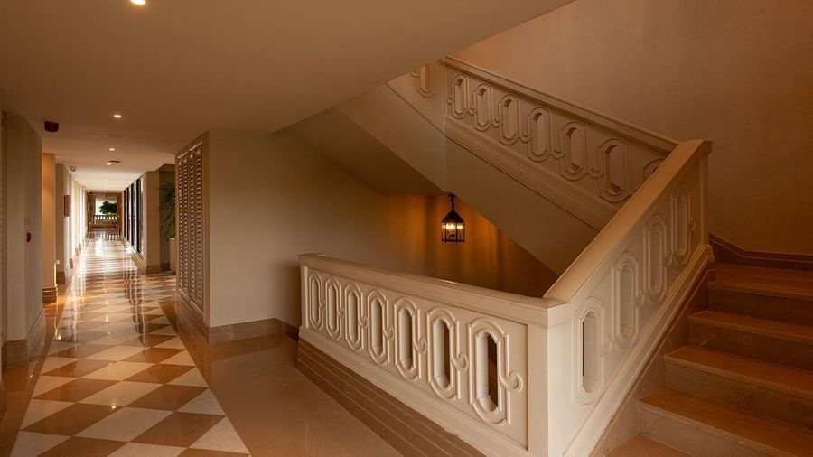 A staircase leading to the upper level protected with concrete railings at The Evren, Vagator.