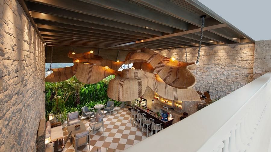 Full view of Suenos de Cafe taken from a higher level featuring an expansive dining area with ample of natural light falling over it.