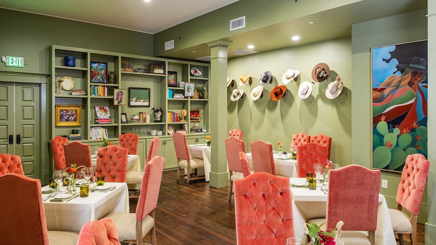 A restaurant interior, featuring chairs, decorated walls, and a neatly arranged dining setup.- The Grand Hotel & Ballroom, McKinney