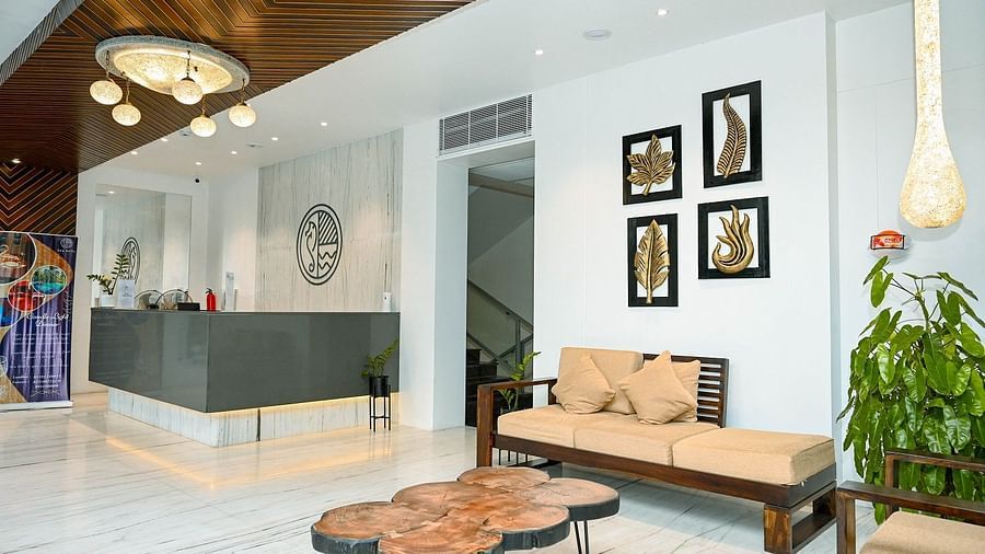A chic hotel reception with modern furniture, decorative lighting, and wall art - Sea Hills Hotels, Sri Vijayapuram (Port Blair)