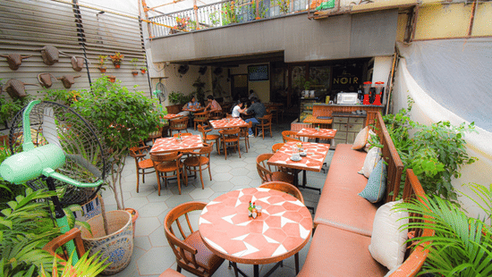 A dining space at King's International Juhu, featuring chairs and tables arranged for a  meal.