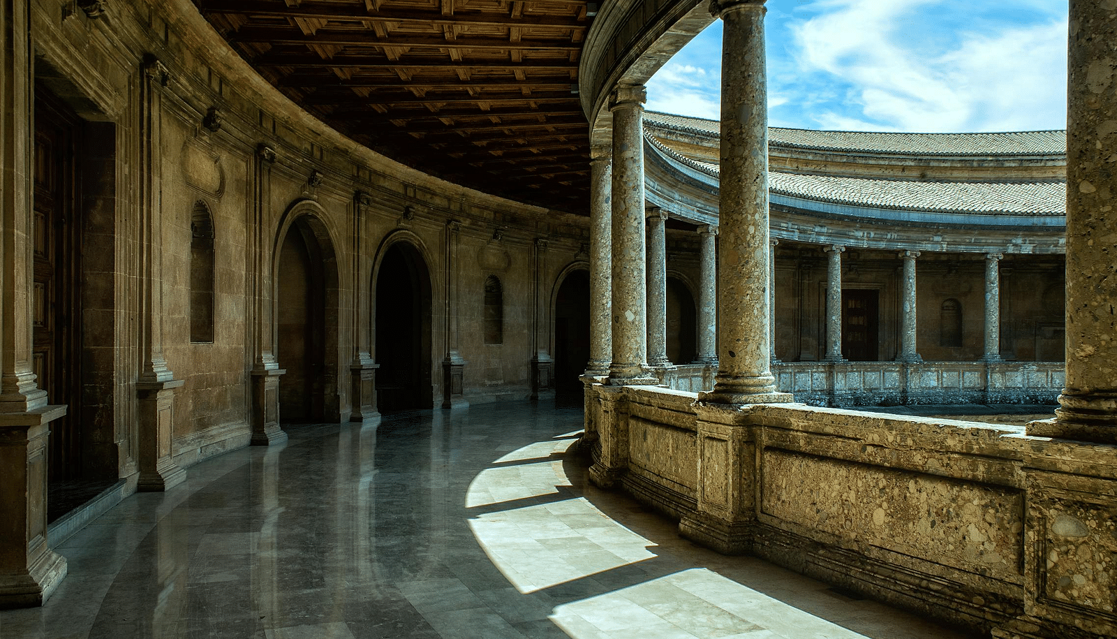 Image of a hallway with curved pillars on the side.