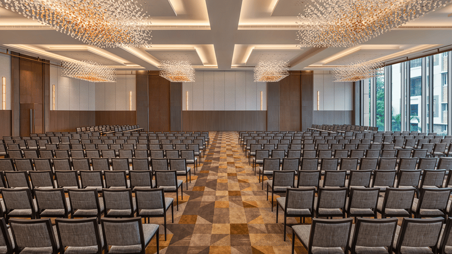 The large Ballroom 1 arranged in a wedding setup with rows of grey chairs facing a screen at The Residency Towers Chennai.