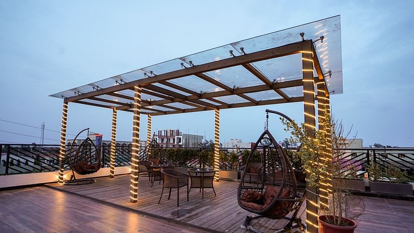 Different types of seats on the terrace with a see through roof - Shanti Seaview Resort & Spa