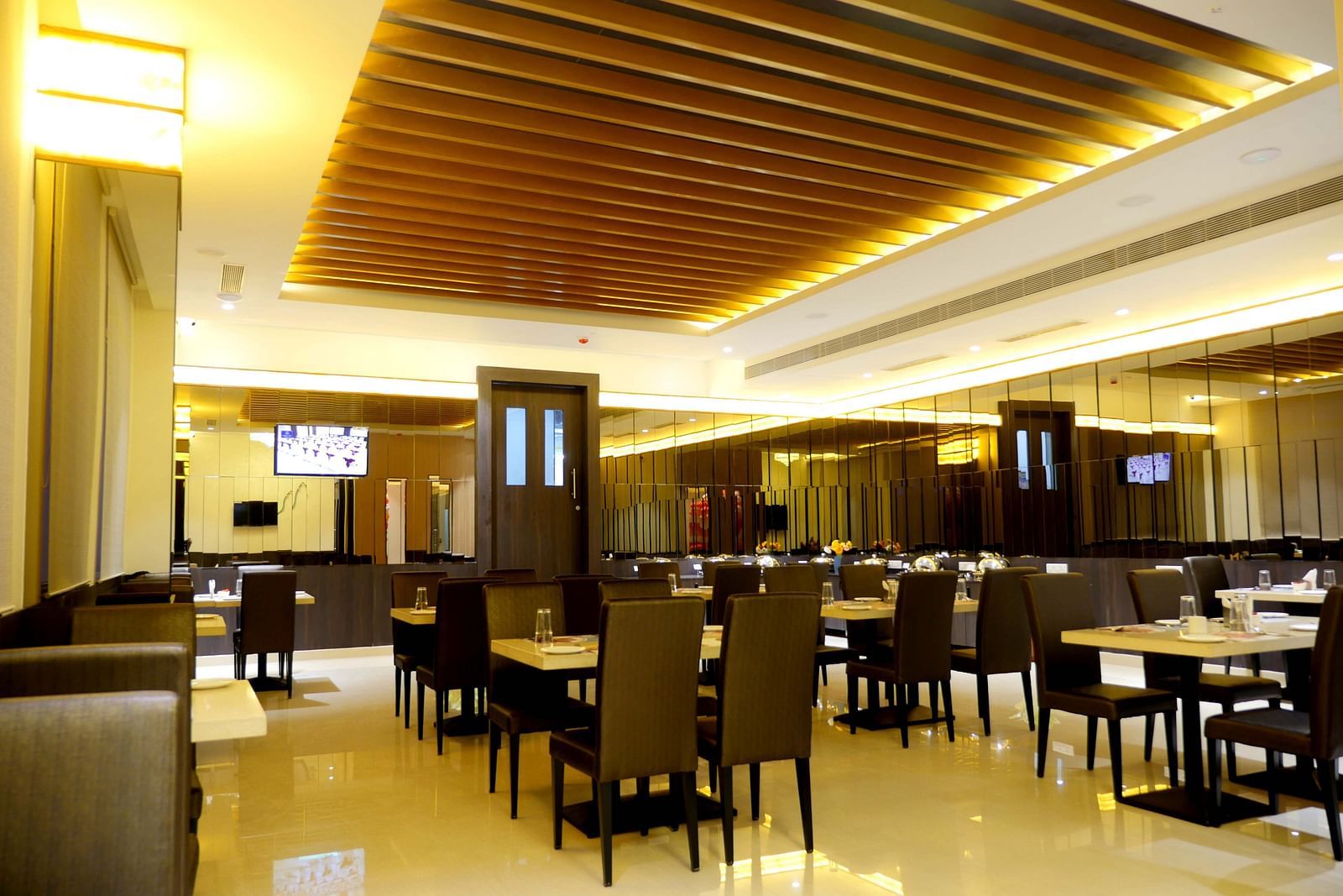 dining of a restaurant with warm lights of ASR Parklane, Hosur