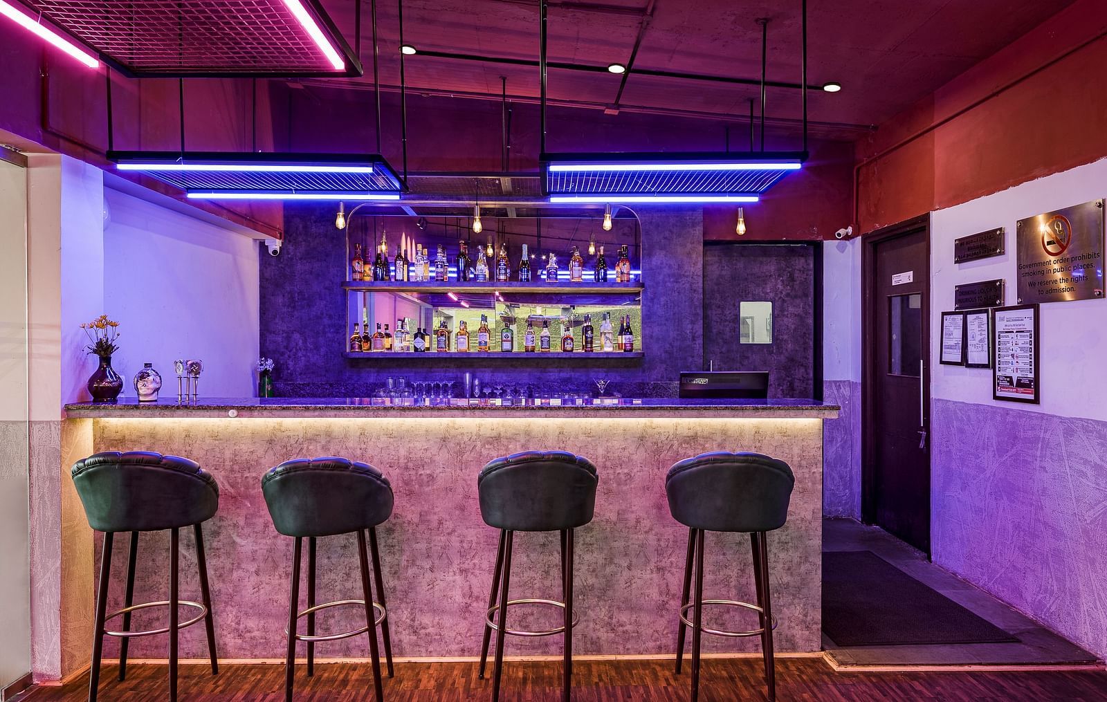 An image of the bar counter with the high raise bar chairs - GReaT Trails Kodaikanal By GRT Hotels