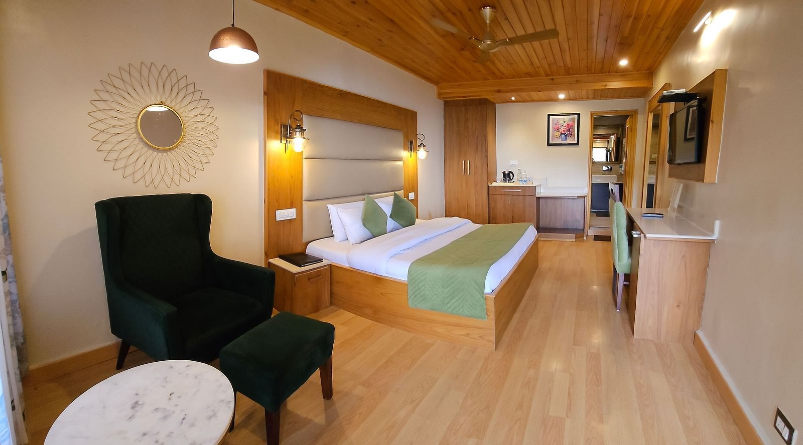 A full view of a room with bed, chair, and a coffee table | Mongas Hotel & Resort, Dalhousie