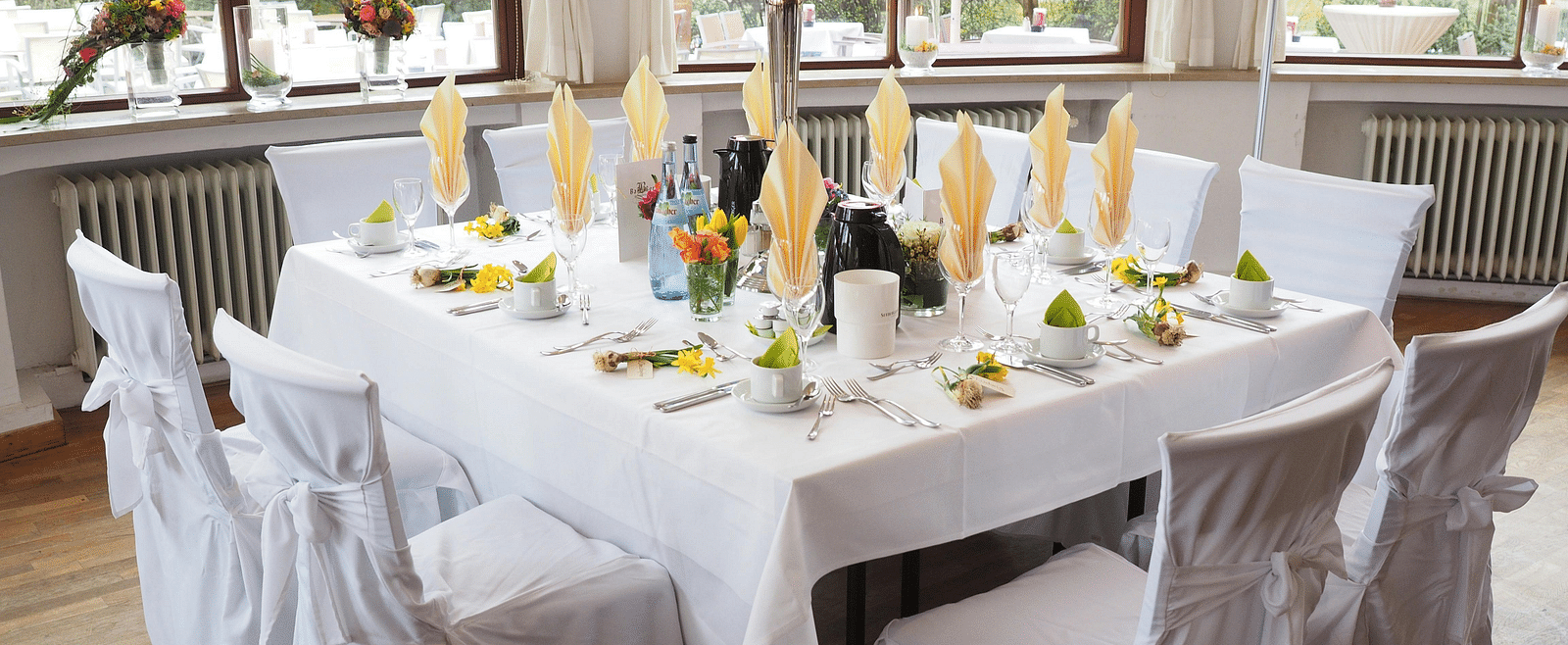A table and chairs, elegantly decorated and arranged for an event.