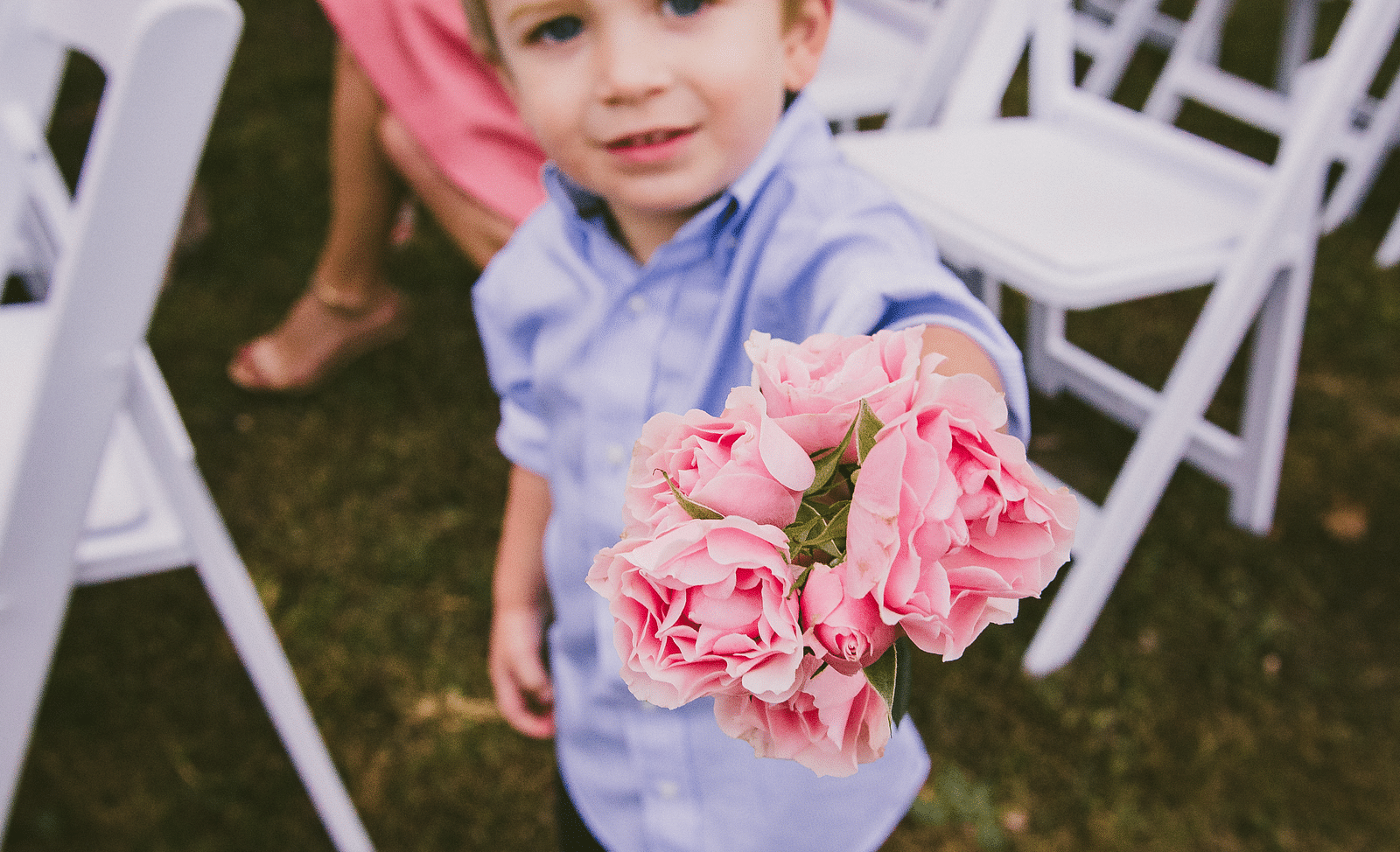a cute toddler with blonde hair holding a bunch of pink roses - Historic Tapoco Lodge