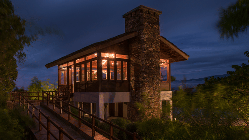 The exterior view of The Serai Resort Bandipur lit up at night