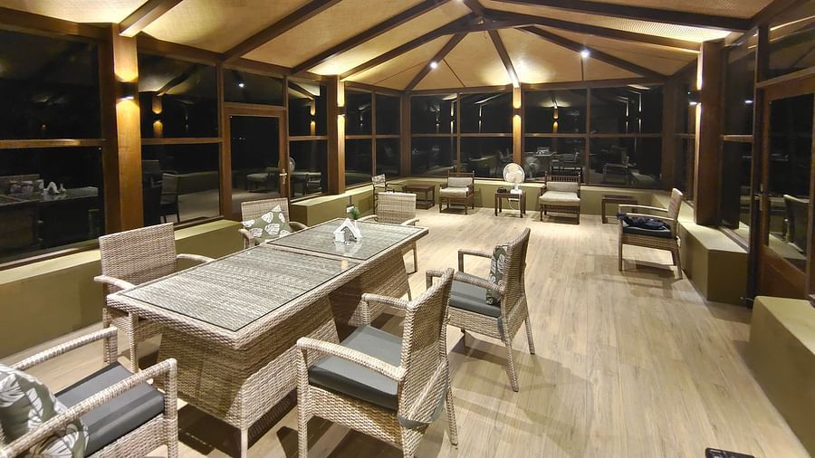interior of a restaurant with tables and chairs in clusters - The Jamoon, Corbett