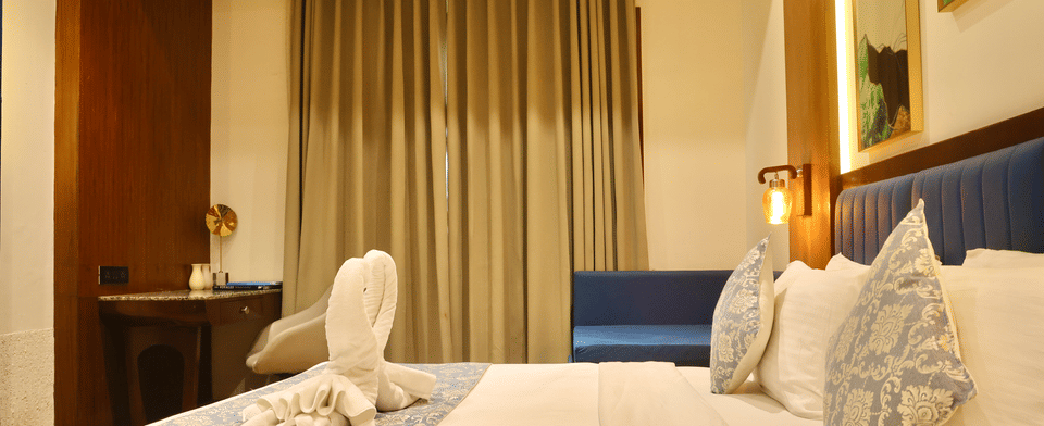 Classic Room, King bed dressed with swan towel art
