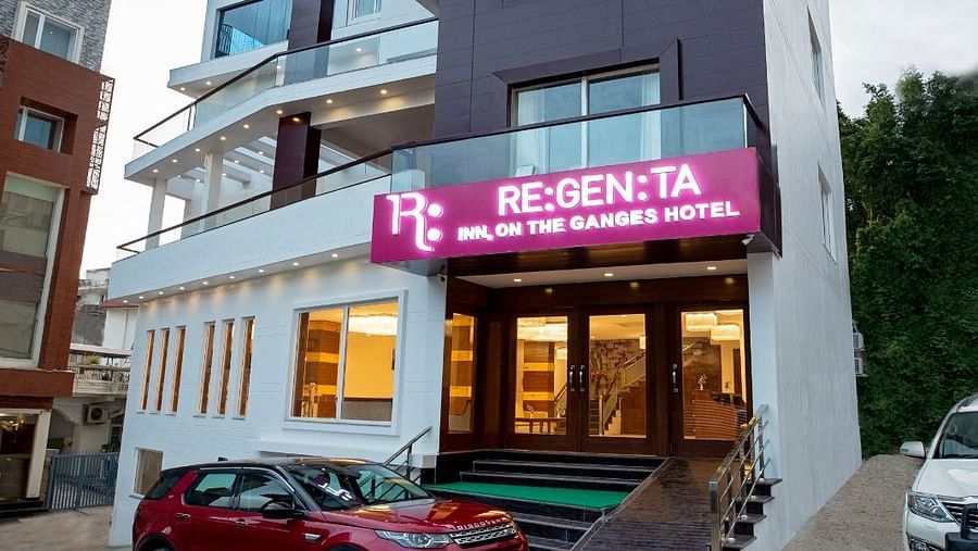 Facade shot of the Regenta Inn DLS featuring a five storey building with a cloudy sky in the background.