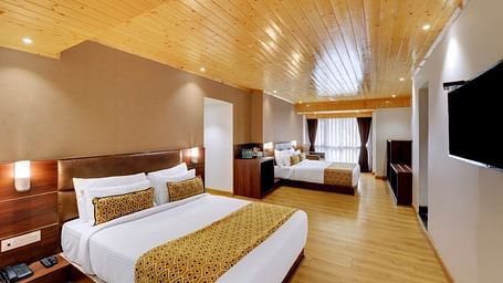 An image of a room with two queen size beds, TV and minimal decoration - Sumitel Vista TV Tower