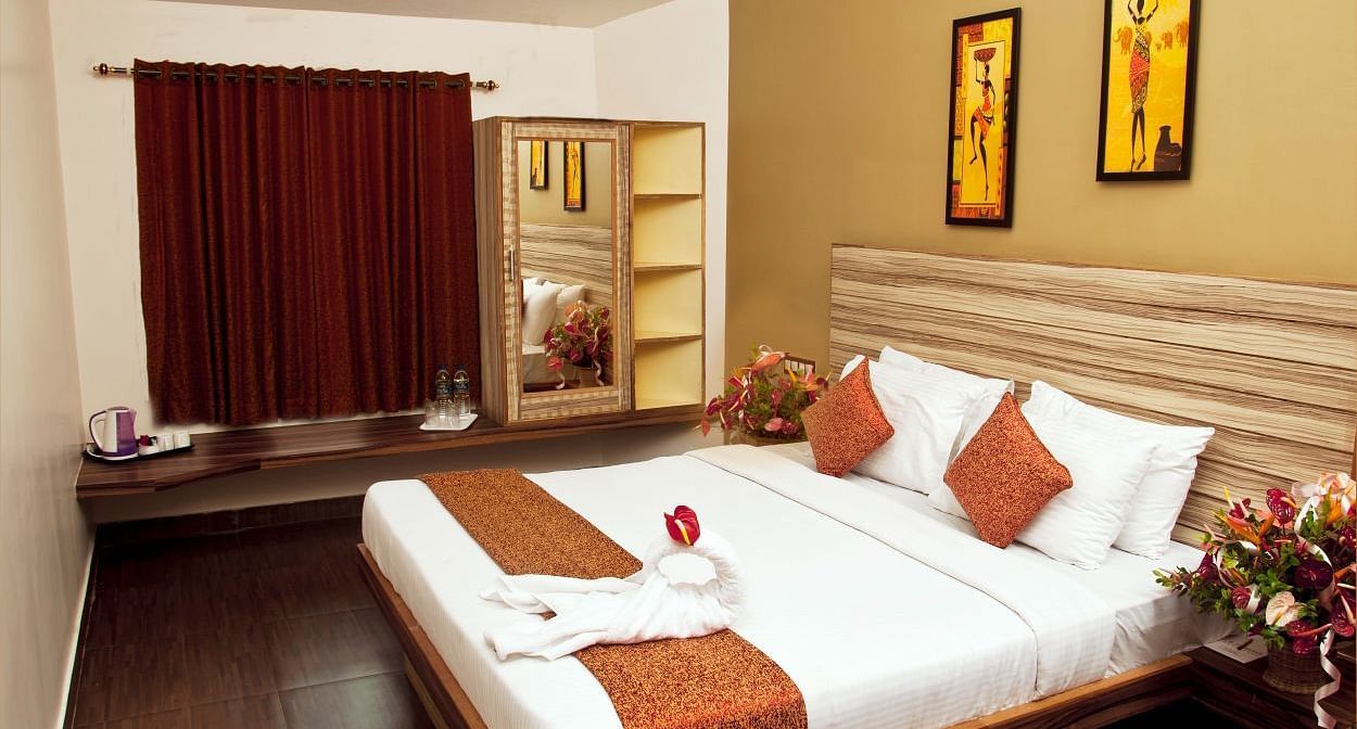 Flora Suite bedroom with a double bed and a wardrobe