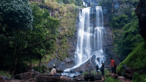 A waterfalls seen with water dropping over a rock.