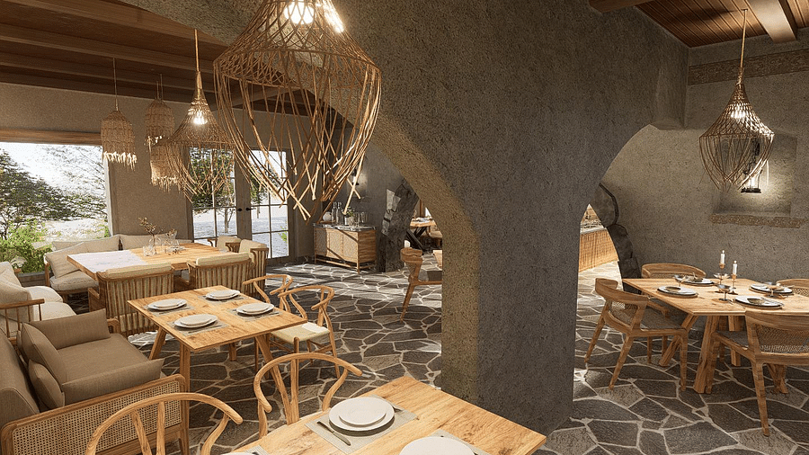 Rustic restaurant with wooden decor, branches, and neatly arranged tables and chairs for guests at The Evren, Vagator.