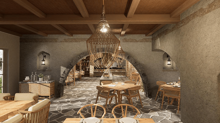 Branch-adorned, wood-themed restaurant with tables and chairs prepared for guests at The Evren, Vagator.