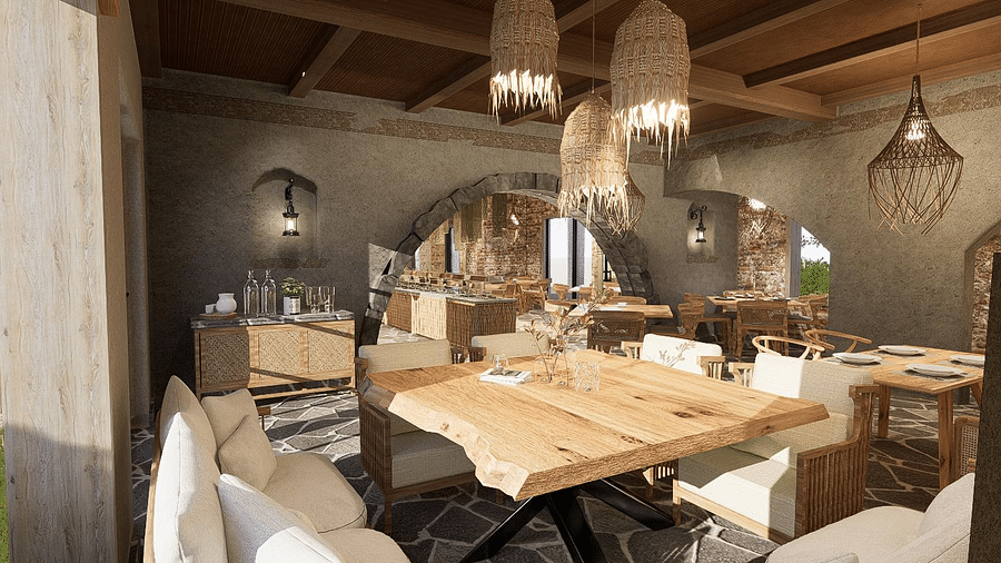 Dining area with neatly arranged tables and chairs, featuring a chandelier hanging from the ceiling at The Evren, Vagator.