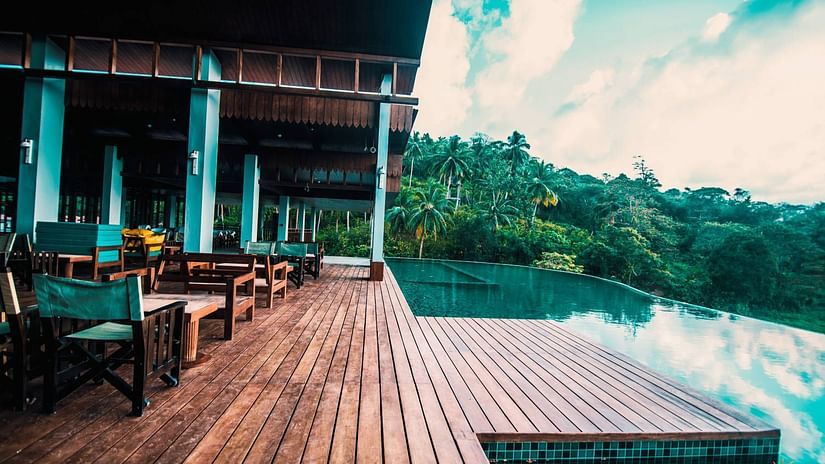 The deck by the infinity pool at the sunset lounge - Symphony Samudra Beachside Jungle Resort And Spa, Port Blair