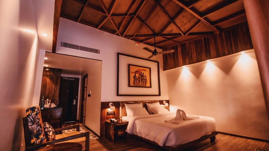 room with a king size bed decorated with wooden interiors and mellow lighting - Symphony Samudra Beachside Jungle Resort And Spa, Port Blair