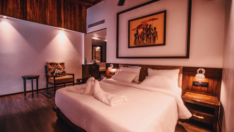 room with a king size bed and wooden interiors at Symphony Samudra Beachside Jungle Resort And Spa, Port Blair