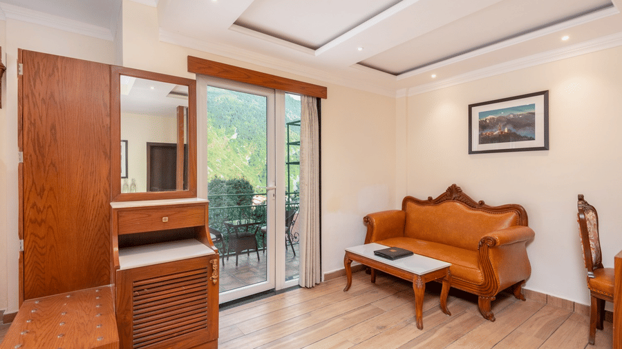 A living area of a family suite with a sofa, a coffee table, and a balcony at Quality Inn.