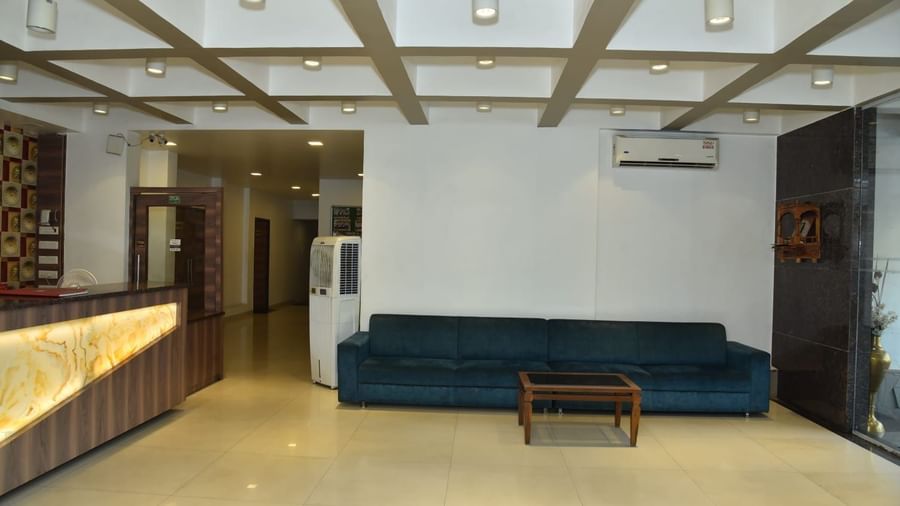 The lobby area of Highland Resort features a long upholstered sofa, and a reception desk.