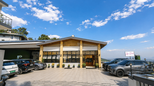 Exterior view of the resort with scenic hill surroundings at Pride Ashiyana Resort Mussoorie.