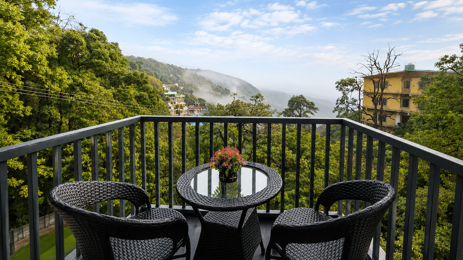 Private balcony seating with panoramic valley views at Pride Ashiyana Resort Mussoorie.