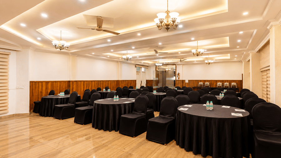 Versatile event venue with round table setup at Pride Ashiyana Resort Mussoorie.