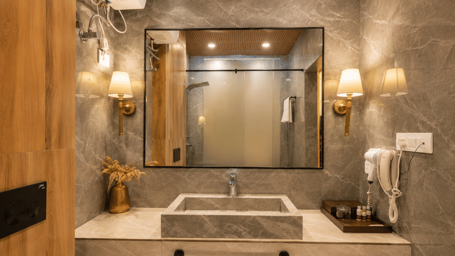 Stylish bathroom with premium fittings and vanity area at Pride Ashiyana Resort Mussoorie.
