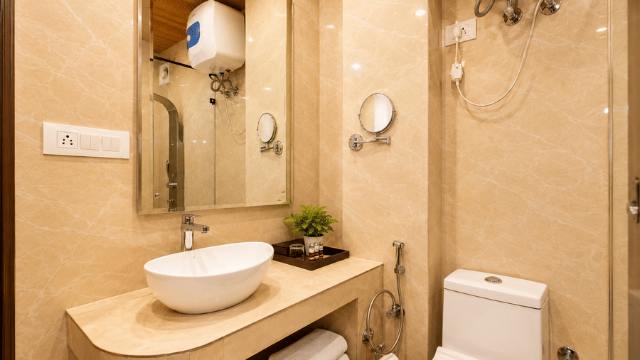 Contemporary bathroom with elegant wash basin and amenities at Pride Ashiyana Resort Mussoorie.