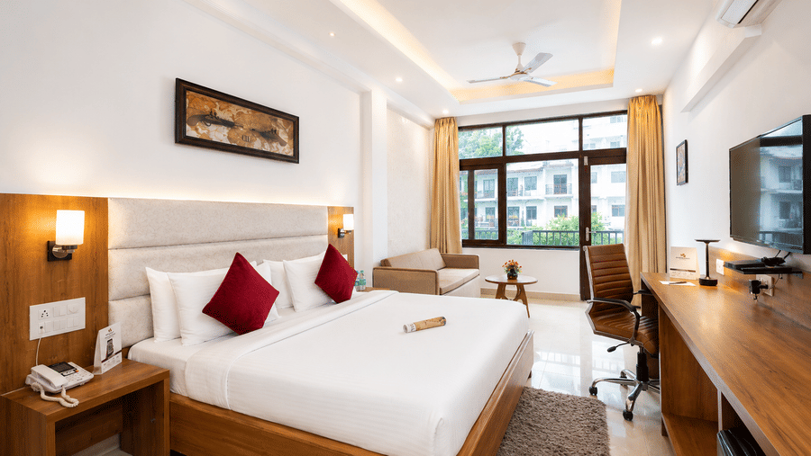 Bright and comfortable guest room with modern furnishings at Pride Ashiyana Resort Mussoorie.