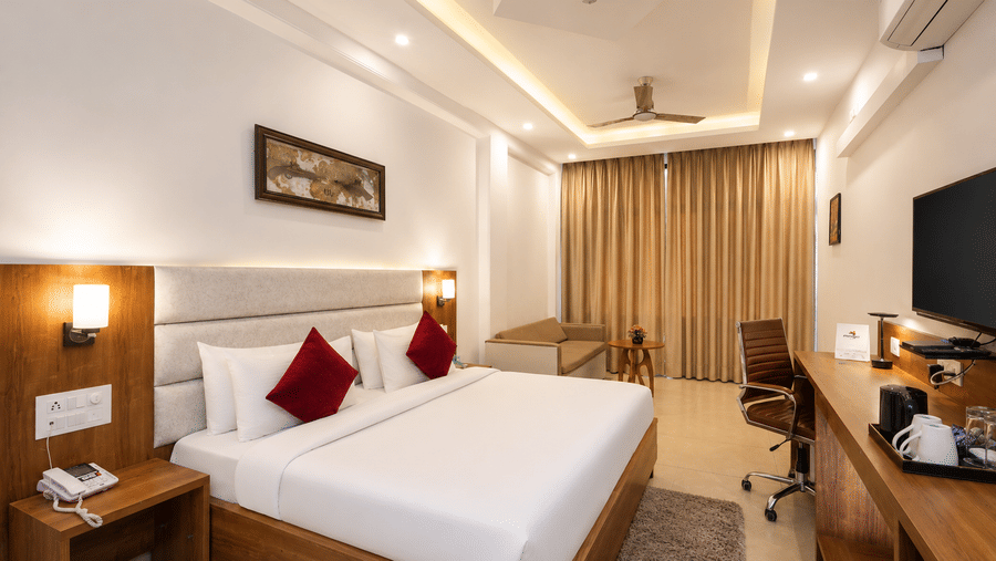 Well-appointed bedroom with cosy interiors at Pride Ashiyana Resort Mussoorie.