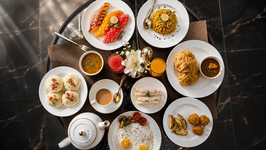 Breakfast spread with assorted dishes and beverages at Pride Ashiyana Resort Mussoorie restaurant.