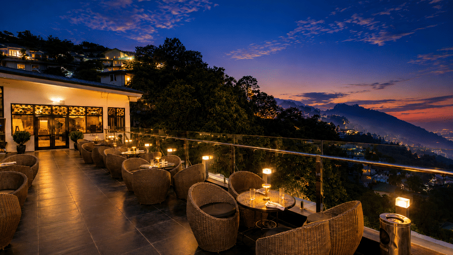 Rooftop terrace dining with stunning evening views at Pride Ashiyana Resort Mussoorie.