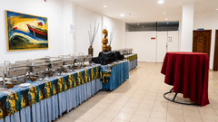 Pre Function Area buffet counter with chafing dishes and elegant red table linen at Chariot Beach Resort, ideal for events and gatherings.