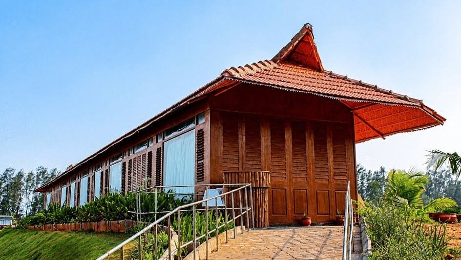 Spa building exterior with a traditional thatched roof design and garden pathway at Chariot Beach Resort, blending nature with wellness.