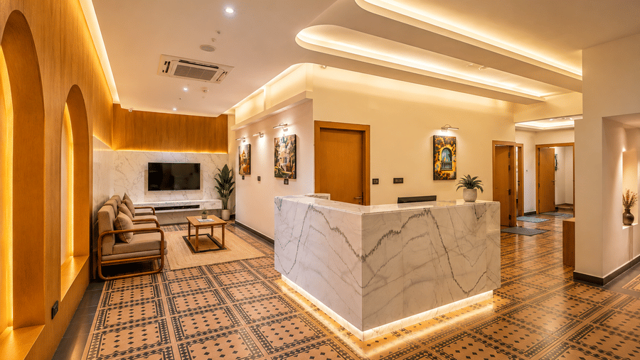 A warm marble reception desk and cosy lobby lounge at BluSalzz Collection - Casa Onze, Arpora.