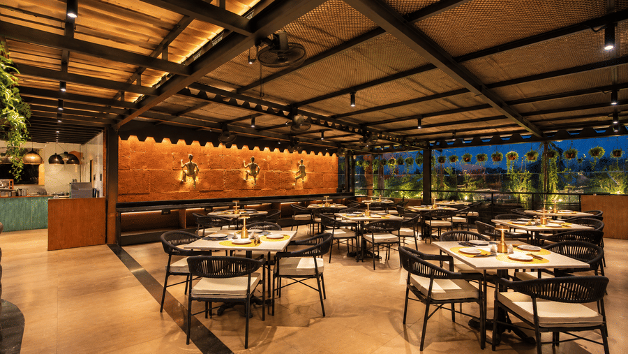 A spacious indoor dining hall offering cosy seating options at BluSalzz Collection - Casa Onze, Arpora.