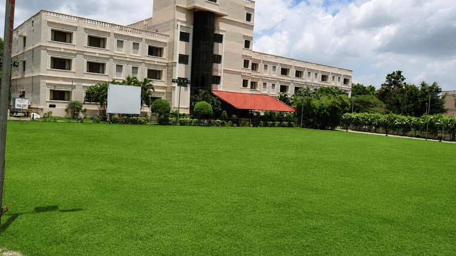 An expansive, manicured green lawn in front of the hotel building suitable for outdoor functions - Jenneys Residency, Coimbatore