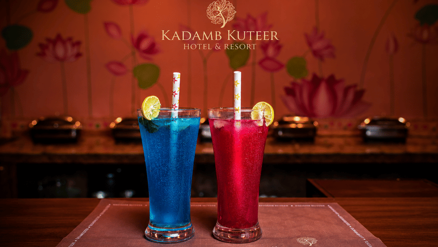 Blue and pink mocktails served on a placemat at Kadamb Kuteer, Vrindavan.
